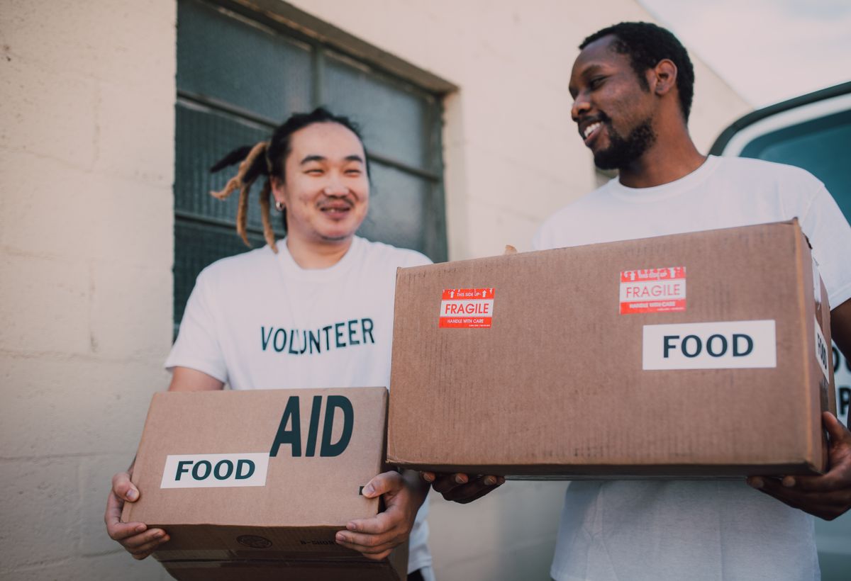 Volunteers handing out donated goods to their community